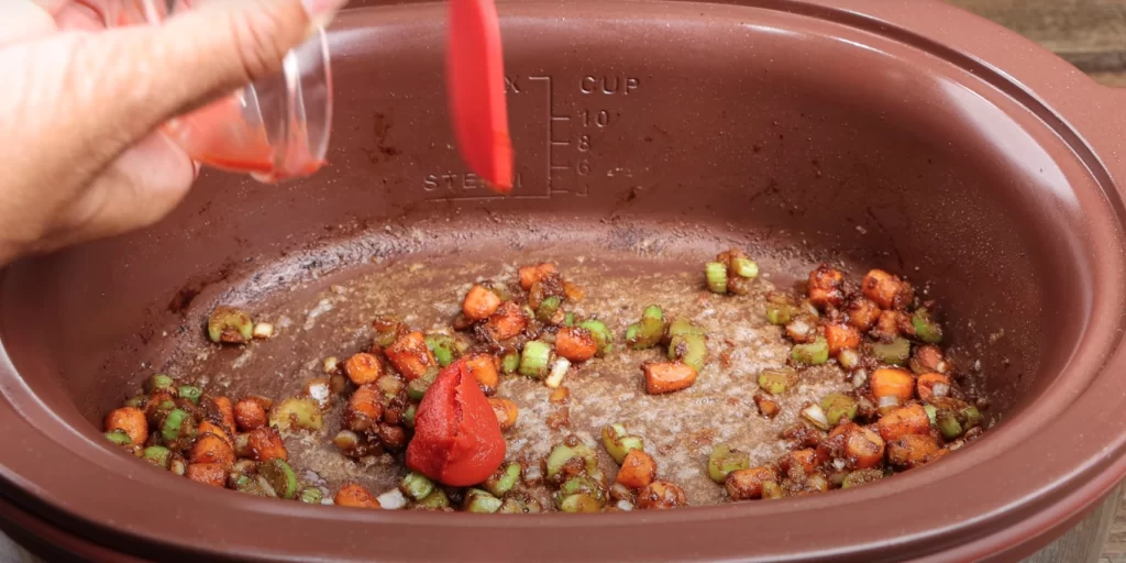 adding the tomato paste to beef stew recipe